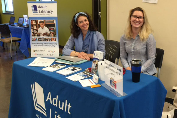 adult literacy staff at a library card sign up table