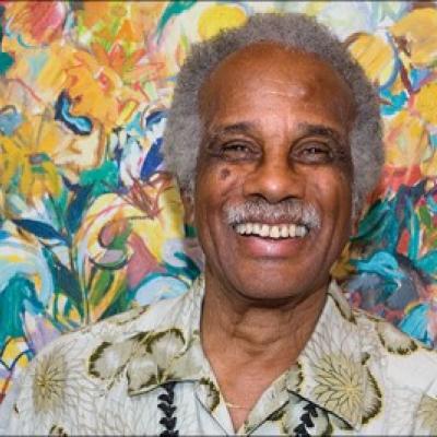 Headshot of Ashley Bryan. He is an older African American man with white hair and a mustache, 